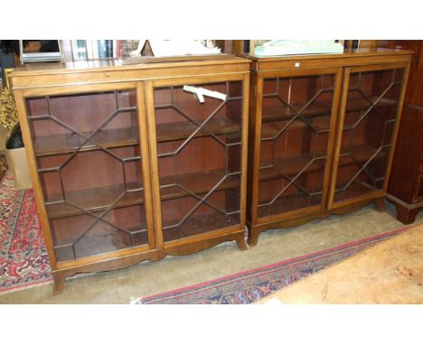A pair of mahogany glazed floor-standing bookcases, each with a pair of astragal-glazed doors, on bracket feet, 123cm wide, 1