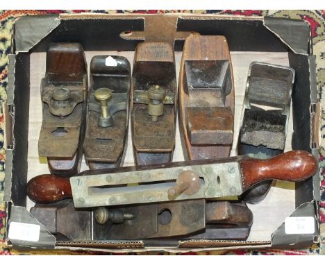 Five wood and steel woodworking planes and other tools.