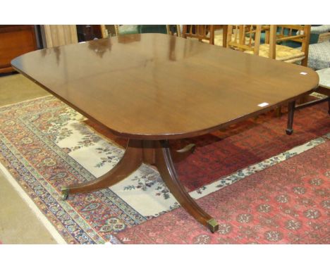 An early-19th century mahogany breakfast table, the rectangular top with rounded corners, on turned column and tripod support