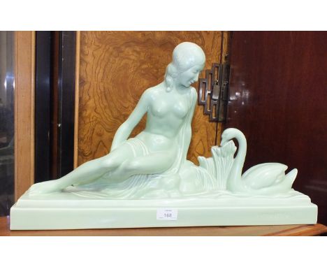 A green ceramic Art Nouveau figure of a woman with a swan, 58cm long, 32cm high and an Art Nouveau-style figure of a nude wom