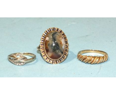 A 9ct gold knot ring set diamond points, size J, 1.9g, a 9ct gold rope-twist ring, size O½, 2.1g and a 9ct gold ring set larg