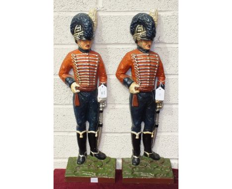 Two 20th century painted cast metal door stops of figures in military uniform, 61cm high, (2).