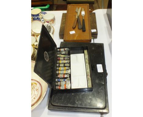 A Winsor &amp; Newton japanned metal oil paint case with paints and palette, 32.5 x 21.5cm, a similar, smaller Reeves &amp; S