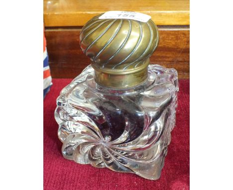 A heavy moulded glass inkwell with brass lid, a brass figure of a gecko with ruby-coloured eyes and other metal and miscellan
