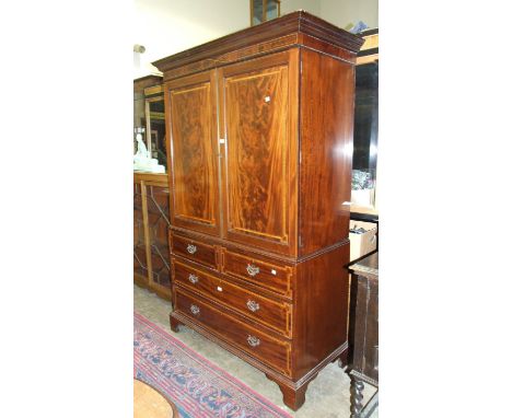 A late-19th century inlaid and cross-banded mahogany linen press, the cornice above a pair of doors, two short and two long d