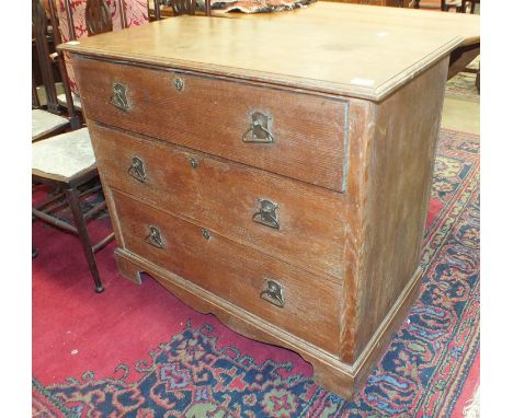 An Edwardian three-drawer oak chest with Art Nouveau brass handles, on bracket feet, 99cm wide.