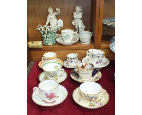 A 19th century Continental tea cup and saucer decorated with birds and flowers, a Royal Worcester tea cup and saucer painted 