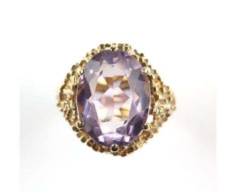 Vintage single stone amethyst ring, oval cut amethyst, weighing an estimated 9.15 carats, claw set, with a bark effect galler