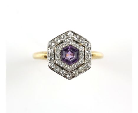Early 20th C amethyst and diamond target ring featuring a hexagonal cut amethyst with two old cut diamond surrounds, shank te