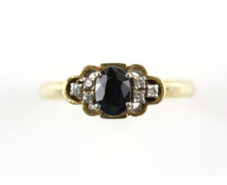Modern sapphire and diamond ring, central oval cut blue sapphire, estimated weight 0.75 carats, set in-between six round bril