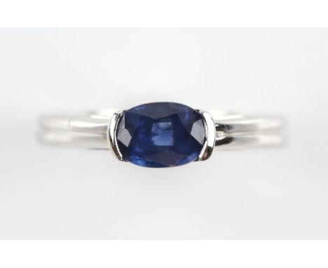Contemporary sapphire ring, oval cut sapphire, estimated weight 0.90 carats, mount stamped 18 ct, ring size M 1/2            