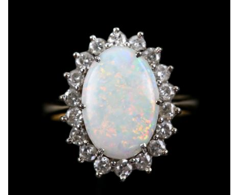 Opal and diamond oval cluster ring, oval cabochon opal, weighing an estimated 1.01 carat, claw set, surrounded by eighteen ro