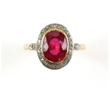 Synthetic ruby and white sapphire oval cluster ring, oval faceted 2.48 carat synthetic ruby surrounded by a halo of white sap