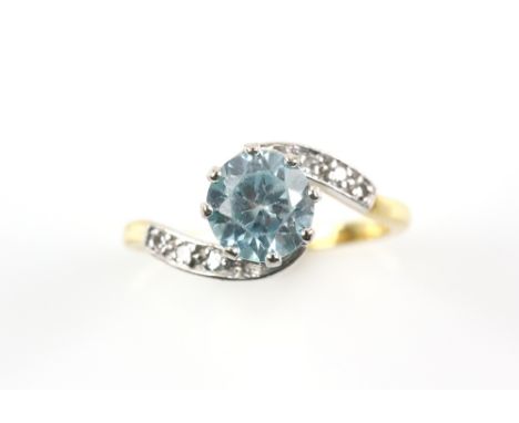 Zircon and diamond twist ring, central round cut blue zircon, estimated weight 2.39 carats, Swiss cut diamond set shoulders, 