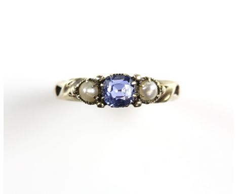 Antique sapphire and pearl ring; cushion cut sapphire, claw-set and flanked by pearls, pierced shoulders, tests as 9 ct, ring