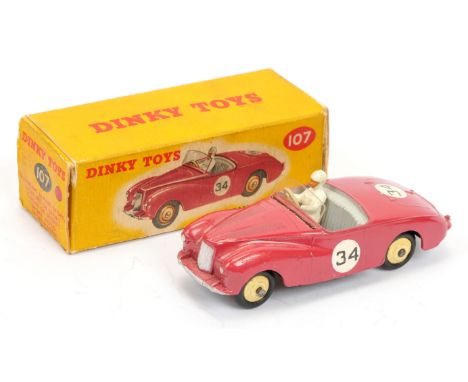 Dinky 107 Sunbeam Alpine Sports Car - cerise body, grey interior with driver figure , silver trim, light beige ridged hubs wi
