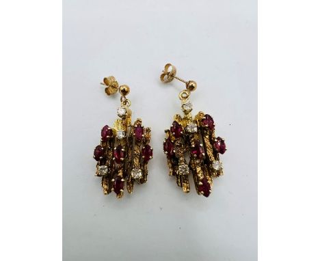 A pair of diamond and ruby studded brutalist style ear pendants. Unmarked yellow metal, with post fittings and butterfly back