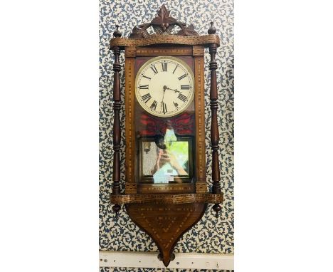 A good American wall clock with 2 train spring driven movement striking on a bell, contained in a decorated marquetry and wal