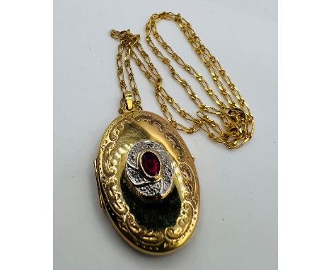 Glass filled ruby and diamond chip set locket. 8.5 grams approximately. 9ct gold on a 9ct gold chain. Import hallmarks for Bi