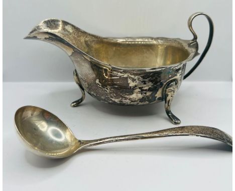 A silver sauce pot and ladle along with a silver christening set:&nbsp; The sauce pot with a scalloped edge can on three feet