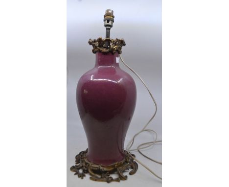 An Ormolu mounted Chinese pink monochrome porcelain vase, 19th Century, the baluster vase with blue seal mark of Qianlong but