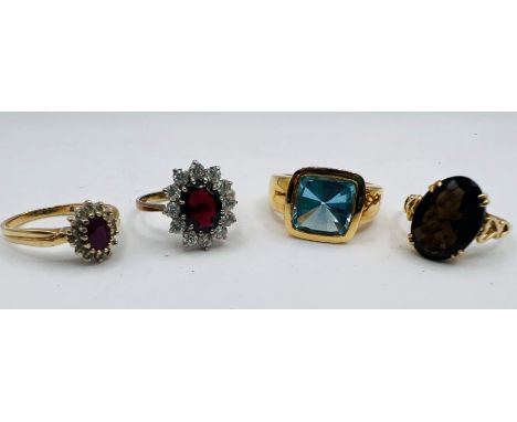 An 18ct gold ring set with a square shaped fancy cut blue topaz, a Smoky quartz 9ct gold dress ring, plus a 9ct gold diamond 