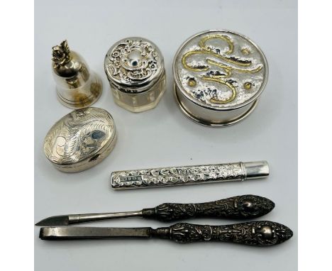 A selection of sterling silver items - comprising a silver handled pair of cosmetics tools, a silver lidded glass pot, a toot