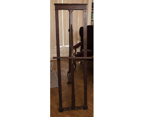 A late 19th Century mahogany artists’ easel, the triple uprights with Chippendale blind fret gothic and fence motifs, hinged 