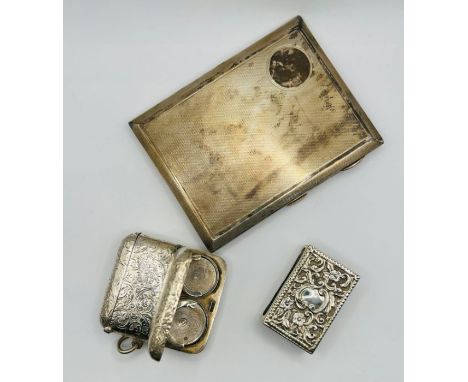 A selection of silver smoking paraphernalia comprising a patterned silver cigarette case, with a gilt lining, hallmarked SB &