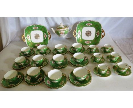Coalport tea and coffee service , decorated with flowers within a green body and enriched with gilding 12 cups, saucer and te