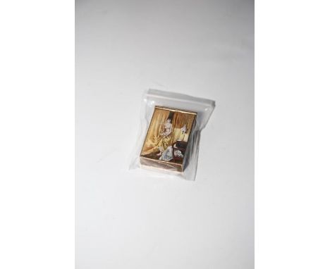 A Continental enamel vesta case, French, circa 1890, the angled hinged lid painted with a parasol and ladies clothes, with nu