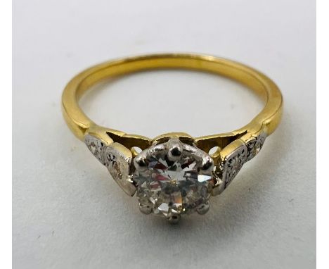 An Art Deco style diamond solitaire ring in yellow metal, unmarked. An old European cut central stone, estimated at approxima