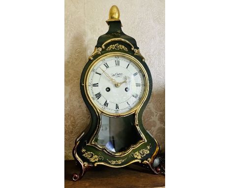 A German lacquered and gilt mantel Neuchateloise clock, 15cm circular enamel dial stamped Du Chateau, Roman numerals with twi