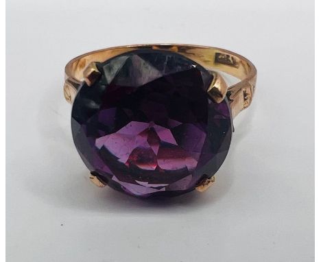 A synthetic colour change sapphire cocktail ring. Diameter of stone 13mm, approximately. The stone appears pinkish purple und