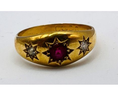 A gypsy set ruby and diamond trilogy ring, featuring two old european cut diamonds in 18ct gold. Size Q1/2. Approximate weigh