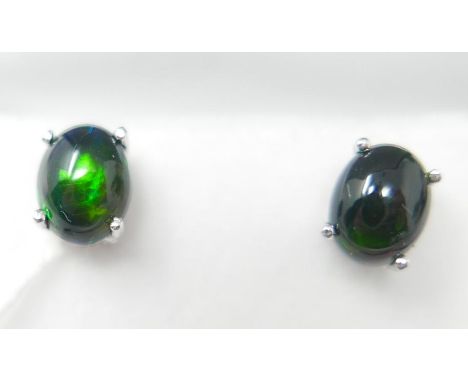 A boxed pair of sterling silver, black opal cabochon stud earrings (flashes of green, blue and red), Opal: 7 x 5 x 4mm each, 