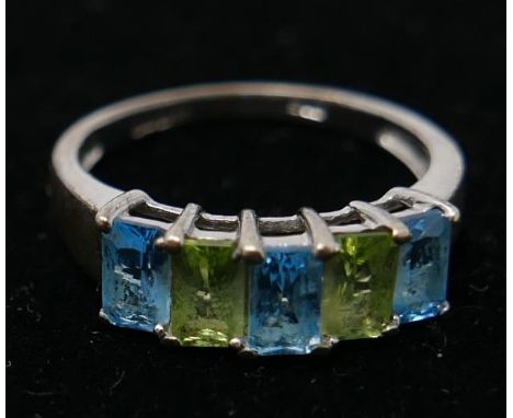 A 9ct white gold five stone ring, set with cushion cut aquamarine and green gemstones 