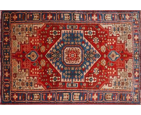 A North West Persian Nahawand rug, central diamond medallion with repeating petal motifs on a terracotta field, within stylis