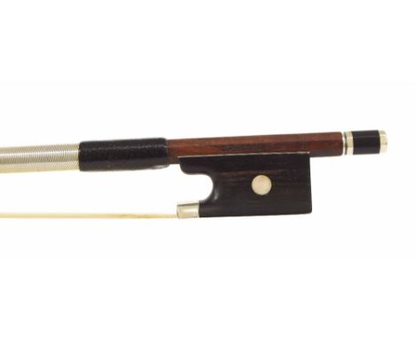 Silver mounted violin bow stamped Caressa, the stick round, the ebony frog inlaid with pearl eyes and the ebony adjuster with