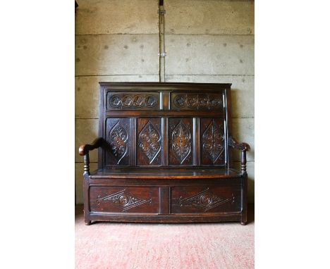 18th century settle, with panelled carved back, hinged seat over unfitted interior, 136 x 143 x 455cm. Good condition.  One p