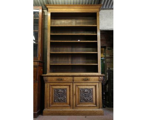 Late 19th/early 20th century open bookcase, on base, with the moulded cornice over adjustable shelves, flanked by fluted colu