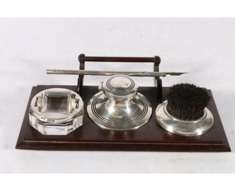 Silver and wood desk tray fitted with a capstan inkwell, a nib wipe and a stamp or envelope roller, 20 x 12cm. 