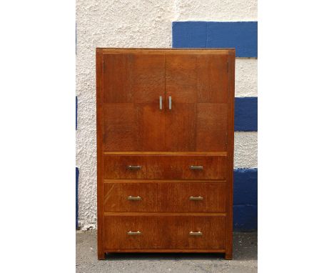 Art Deco limed oak tallboy by Heal's of London, the twin-cabinet doors having quarter panel veneer, above three graduated dra