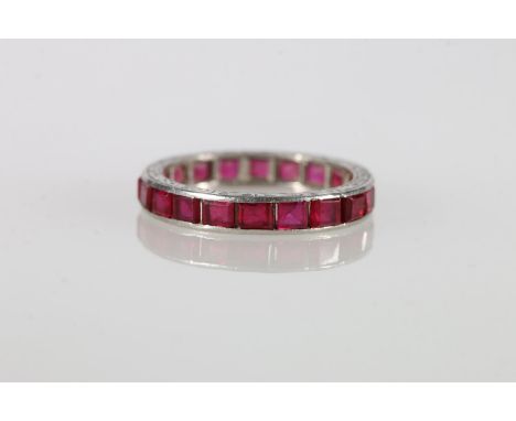 White metal ruby set eternity style ring, possibly platinum, size L/M, 3.5g. Stones appear clear/calibre set.