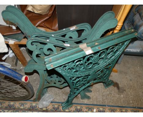 Two pairs of green cast iron bench ends and a pair of cast iron table legs 