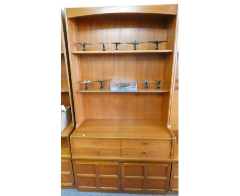 A Nathan teak wall unit, 102cm wide x 194cm tall, the open two shelf top over four drawers and cupboard base 