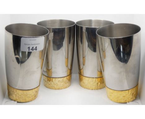 Stuart Devlin for Viners, a set of four stainless steel and gilt metal beakers 