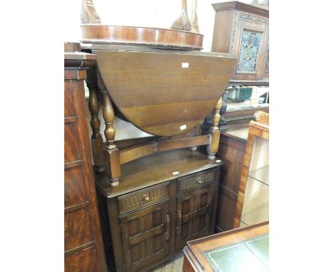 A 1950's two door cupboard, a mahogany oval gate leg table, a walnut hall table, a tea trolley and a tray