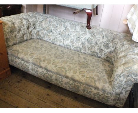 A three seat button back Chesterfield with green and cream floral upholstery