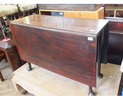 A 19th Century mahogany cottage dining table on pad feet, a cane seat chair and stool